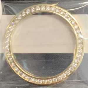 18K Y/G LADIES CHANNEL SET DIAMOND BEZEL FEATURING 1 CARAT OF ROUND BRILLIANT CUT DIAMONDS.