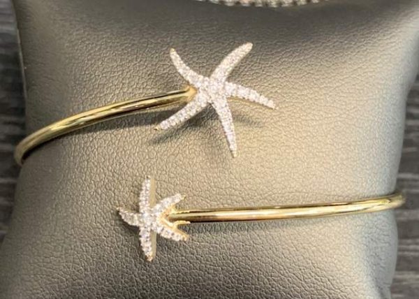 14K Y/G LADIES NAUTICAL STAR FISH BANGLE BRACELET CONSISTING OF 39 PAVE SET ROUND BRILLIANT CUT DIAMONDS ON THE STARFISH WEIGHING .31 PTS. 3.1 DWT.