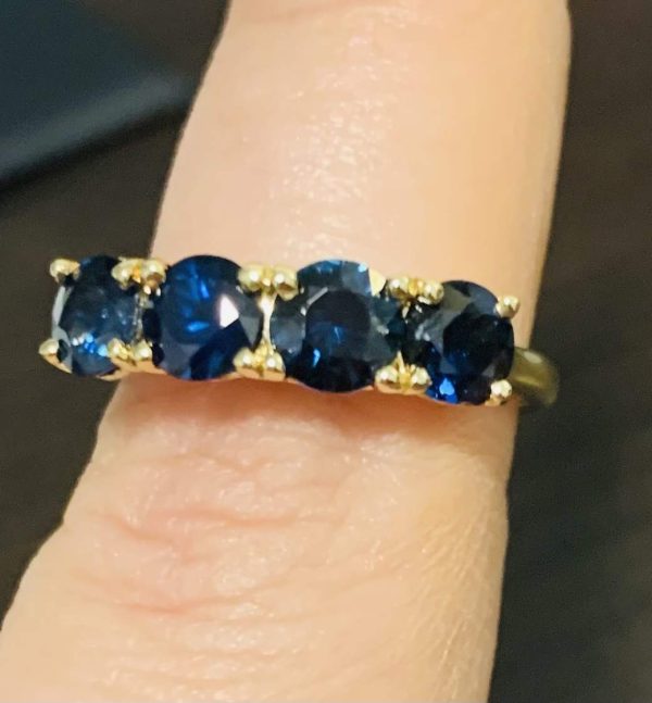 14K YELLOW GOLD LADIES 4 STONE RING/BAND CONSISTING OF 4 EXCELLENT QUALITY/CLARITY BLUE SAPPHIRES WEIGHING .60 EACH AND A TOTAL OF 2.40 CTS. GOLD WEIGHT 2.3 DWT. SIZE 7.