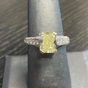PLATINUM DIAMOND ENGAGEMENT RING CENTER DIAMOND ,RADIANT CUT. CARAT WT 2.37CT CLARITY VS-1 COLOR FANCY LITE YELLOW SEE G.I.A. REPORT # 13253132 WITH 30 SMALL ACCENTING DIAMONDS APPROX 50PTS PLATINUM WT 5.1 DWT