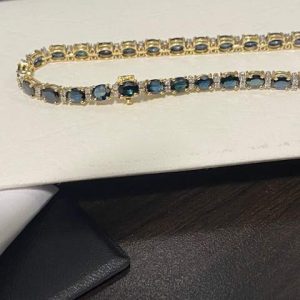 18K Y/G SAPPHIRE AND DIAMOND BRACELET 27 OVAL SAPPHIRES 5 X 4 MM 54 SMALL ACCENTING DIAMONDS 7.8DWT