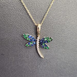 14K YG DRAGONFLY PENDANT. 14 SAPPHIRES .28CT, 11 DIAMONDS .05CT, 14 GREE GARNET .024 ON 18" CHAIN. 1.7DWT