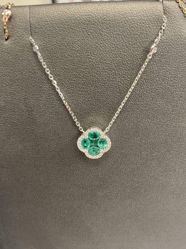 18K W/G ALHAMBRA INSPIRED STYLE EMERALD AND DIAMOND NECKLACE FEATURING 0.95 CTS OF EMERALDS AND A DIA HALO CONSISTING OF 0.25 PTS ON A ADJUSTABLE D.B.Y 16" CHAIN. 2.8 DWT.