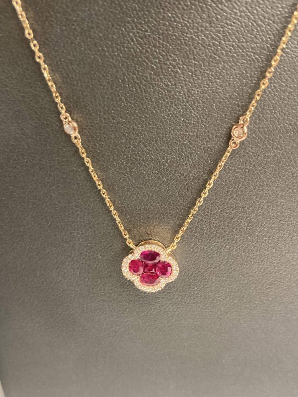 18K ROSE GOLD ALHAMBRA INSPIRED STYLE RUBY & DIA NECKLACE FEATURING 1.03 CTS OF RUBIES AND 0.24 PTS OF DIA IN HALO ON A 16" D.B.Y ADJUSTABLE CHAIN. 2.8 DWT.
